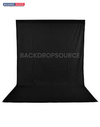 Solid black studio muslin backdrop for professional photography sessions, ideal background solution for portraits.