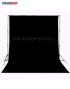 Solid black studio muslin backdrop for professional photography sessions, ideal background solution for portraits.