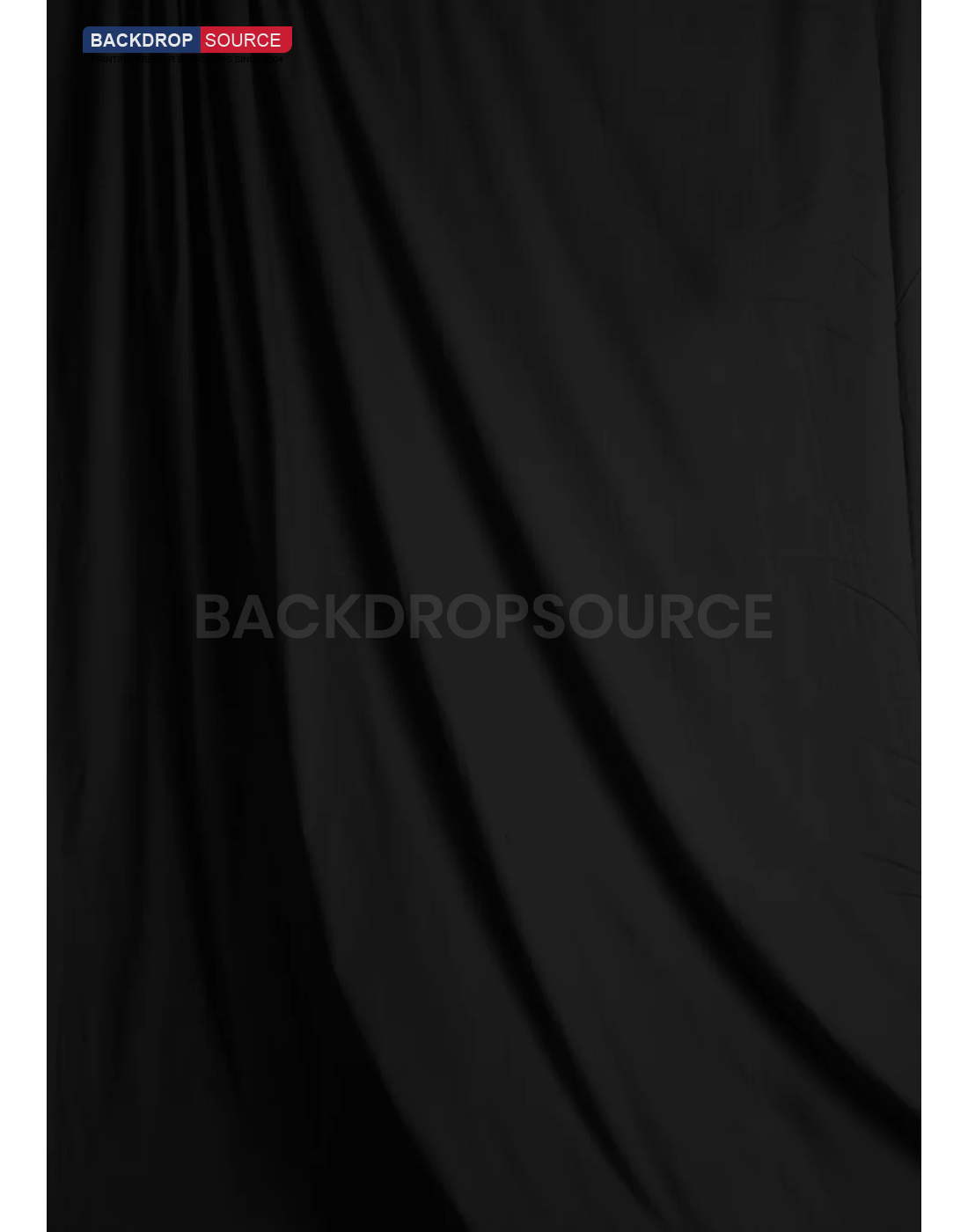 Solid black studio muslin backdrop for professional photography sessions, ideal background solution for portraits.