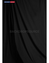 Solid black studio muslin backdrop for professional photography sessions, ideal background solution for portraits.