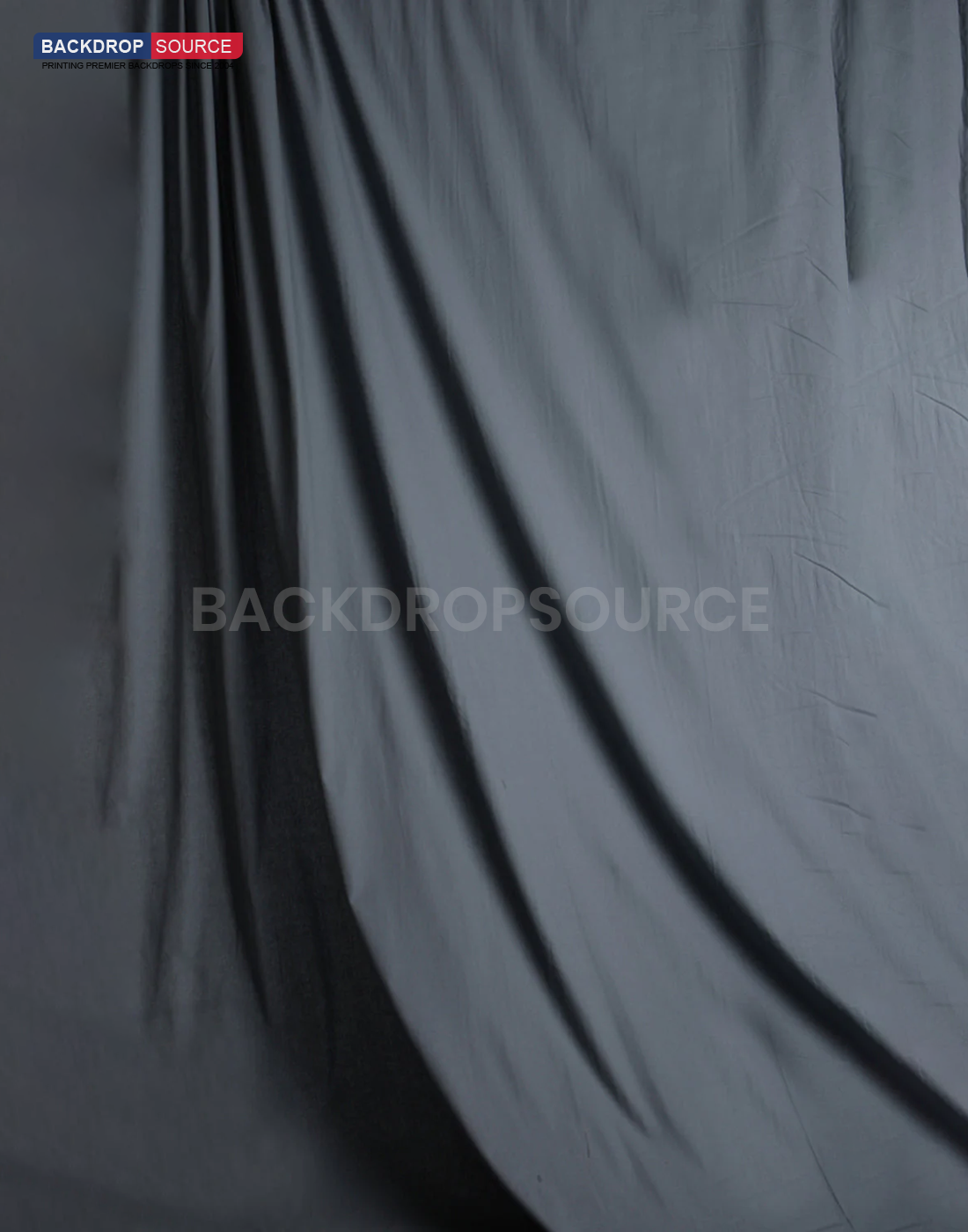 Grey photography muslin background featuring a seamless, professional studio setup for modern portrait shoots.