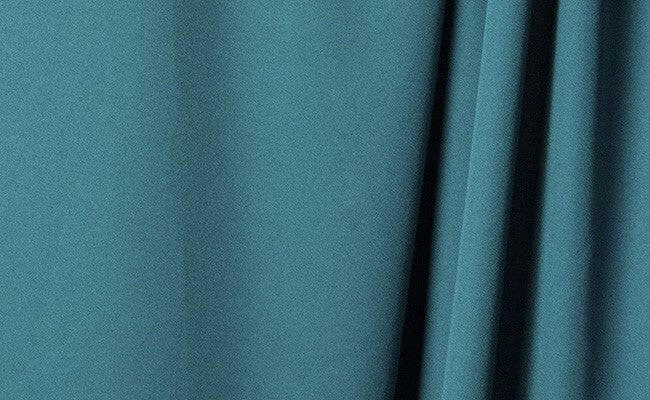 Jade wrinkle-resistant background displaying smooth, elegant fabric for professional product presentations.