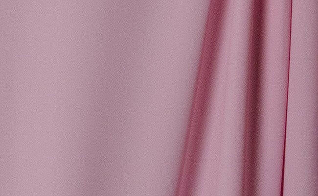 Passion Pink wrinkle-resistant background featuring smooth, vibrant pink fabric ideal for professional photography.
